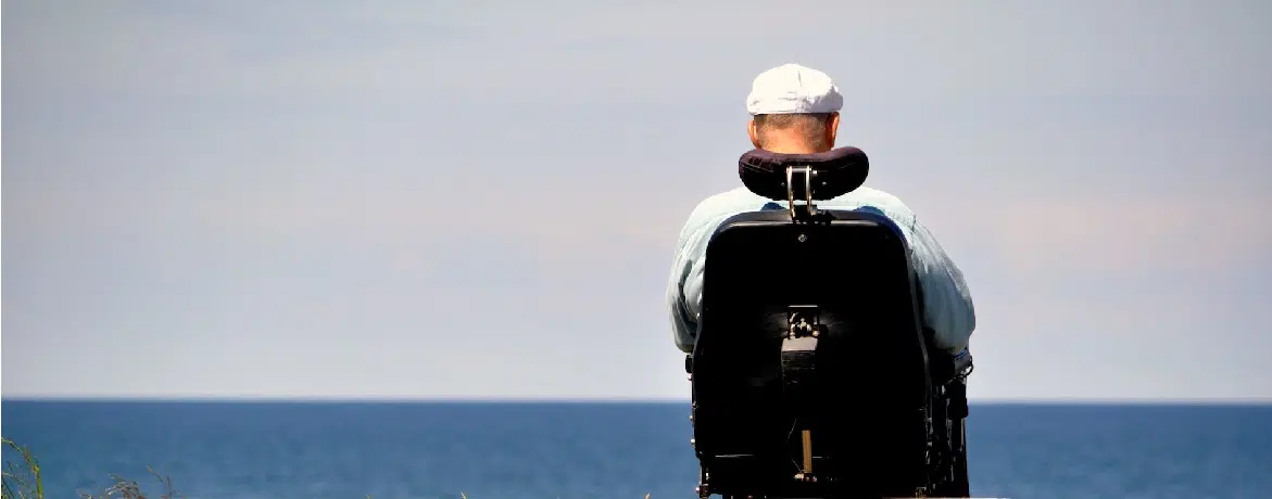 man in wheelchair overlooking the water