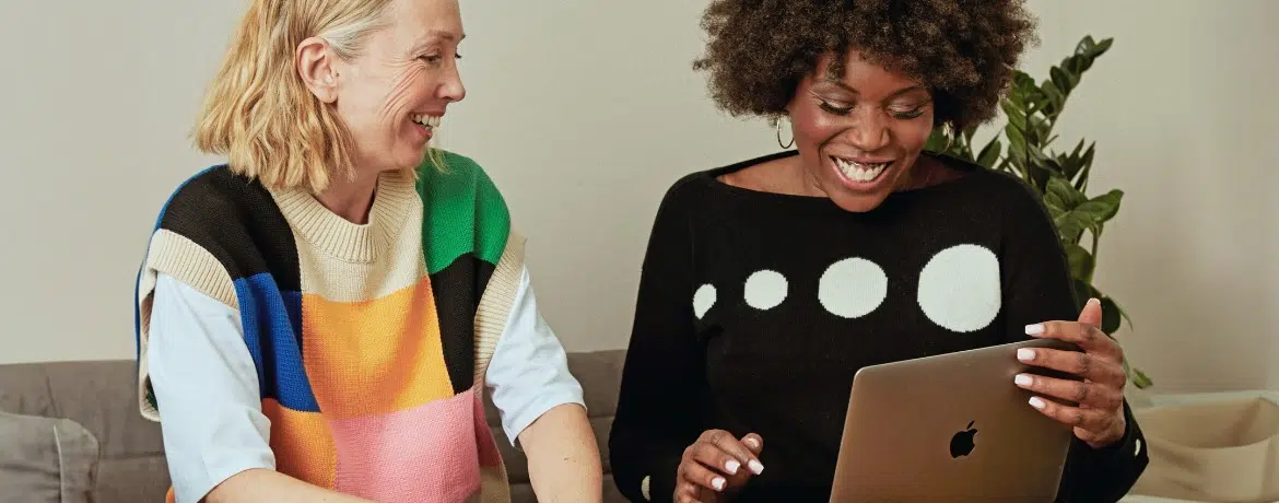 two women looking at laptop screen